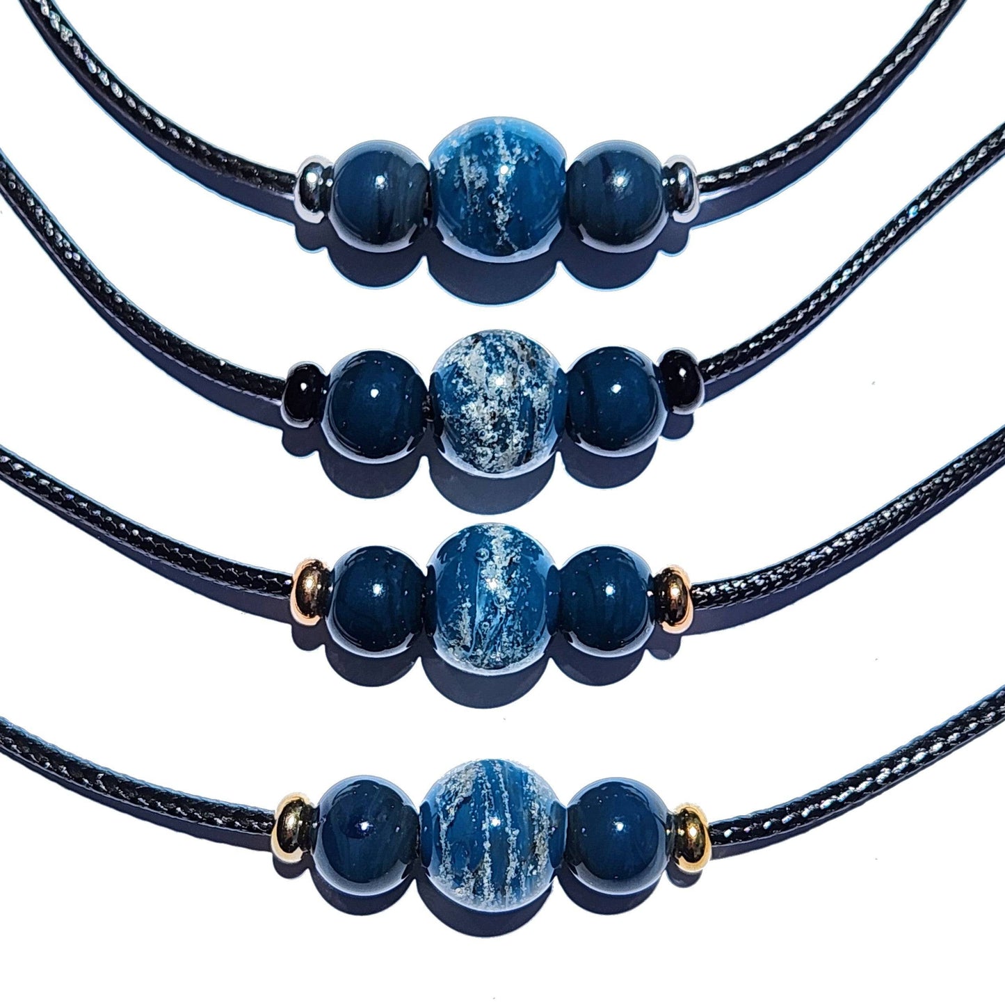 Four blue Forever Close Ashes Necklaces with ash-infused beads and mixed metal finishes. Custom cremation jewelry for memorials.