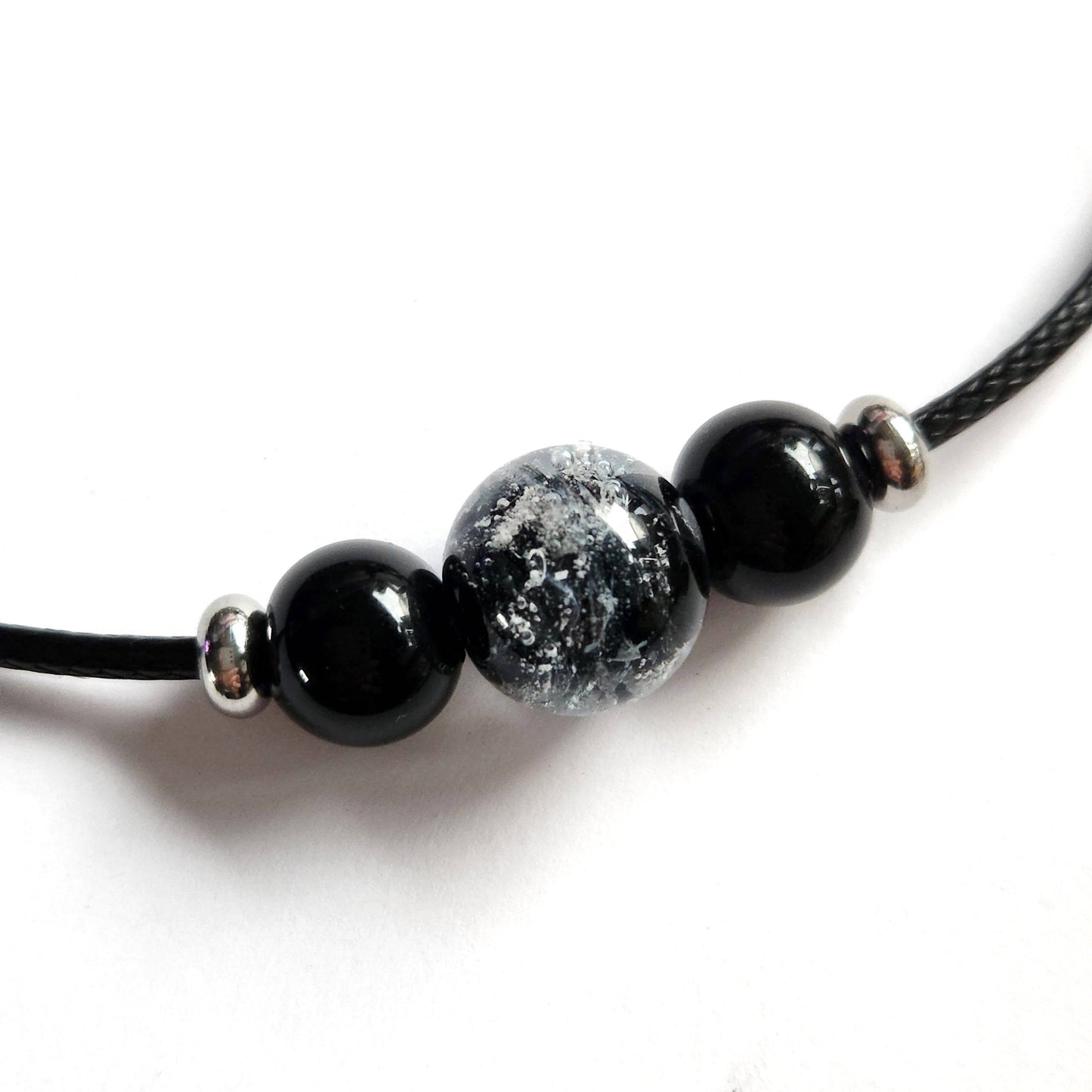 Forever Close Ashes Necklace with black cremation beads and ash-infused center bead. Elegant memorial jewelry on braided black cord.