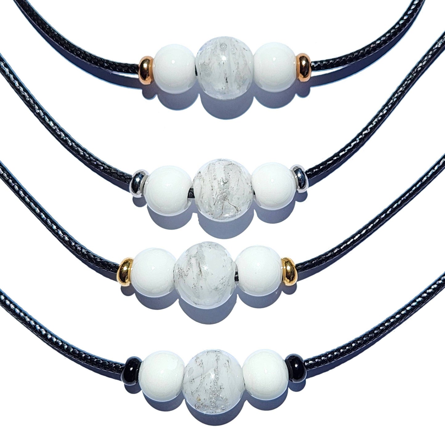 Set of four white Forever Close Ashes Necklaces with ash-infused center beads and mixed metal accents. Personalized cremation jewelry.