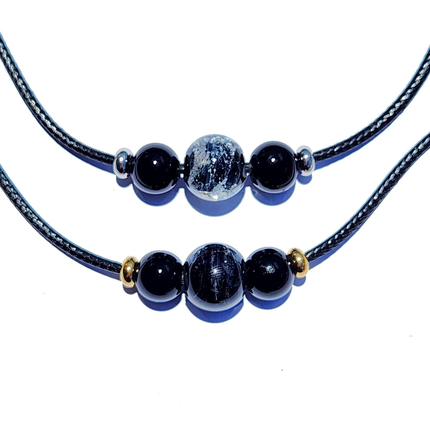 Two black Forever Close Ashes Necklaces with ash-infused center beads and gold or silver accents. Elegant cremation jewelry.