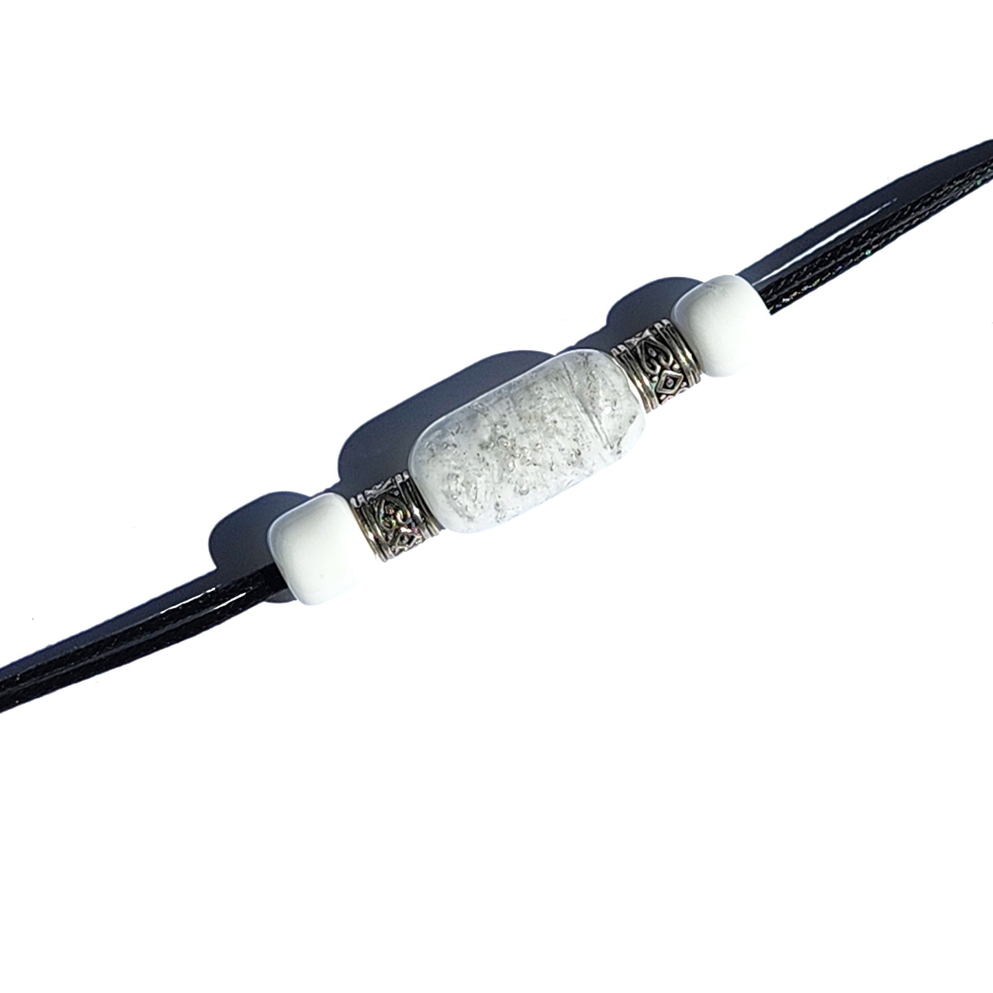 White cremation bracelet with ashes and silver beads on black cord, included in a handmade urn jewelry set for memorials.