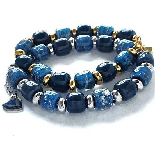 Ocean Blue Memorial Bracelet featuring ash-infused glass cremation beads with gold and silver steel spacers. Handmade tribute jewelry for memorial ceremonies.