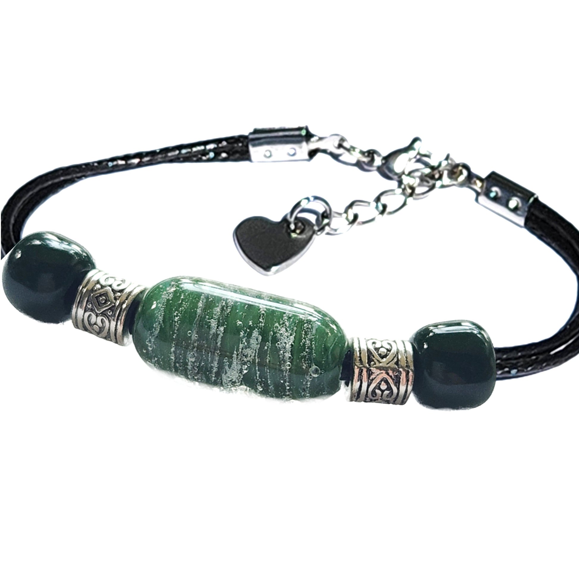 Green Remember Me cremation bracelet with ashes, featuring stainless steel heart charm and handmade cremation bead on black adjustable cord.