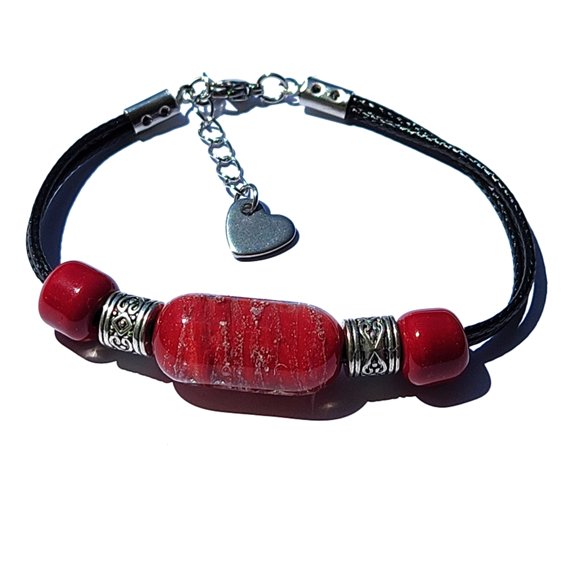 Red Remember Me cremation bracelet with ashes, featuring a central cremation bead, heart charm, and stainless steel accents on a black cord.