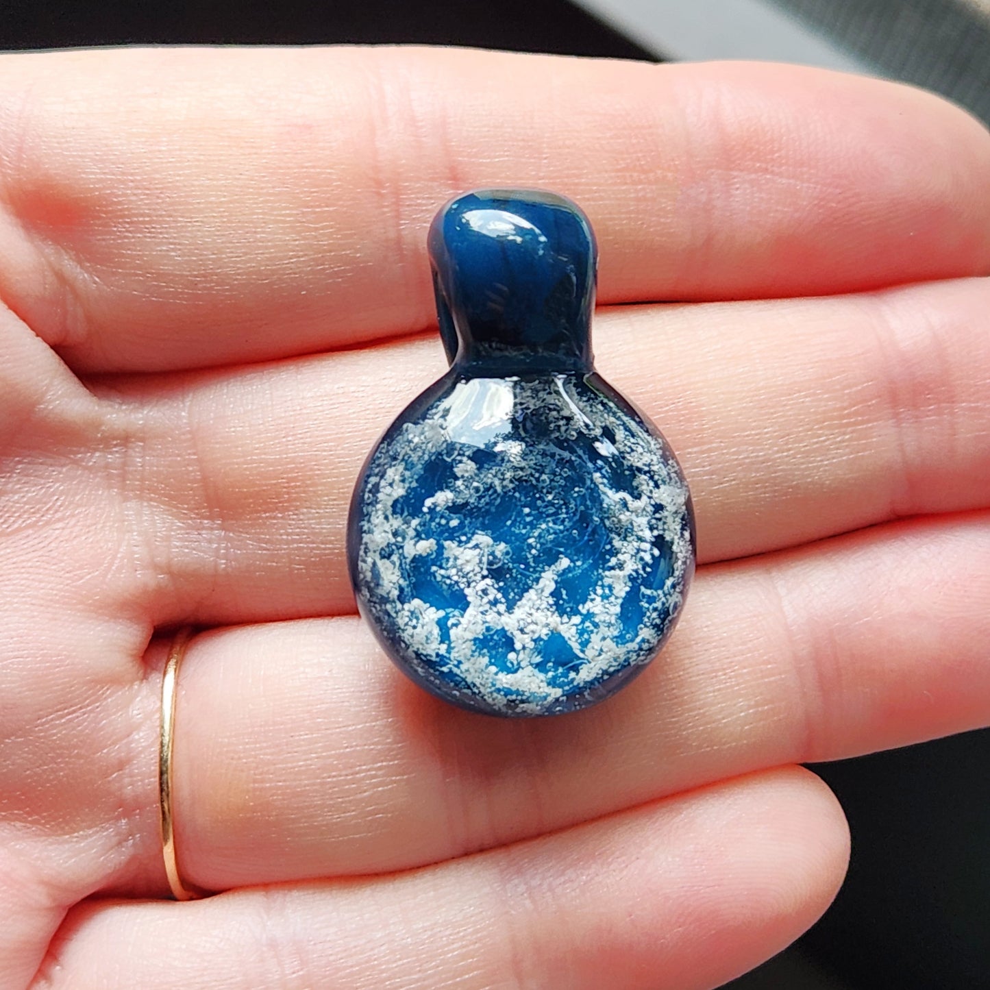 Starred Night - Cremation Pendant Necklace in hand, blue and white ash-infused glass memorial keepsake.