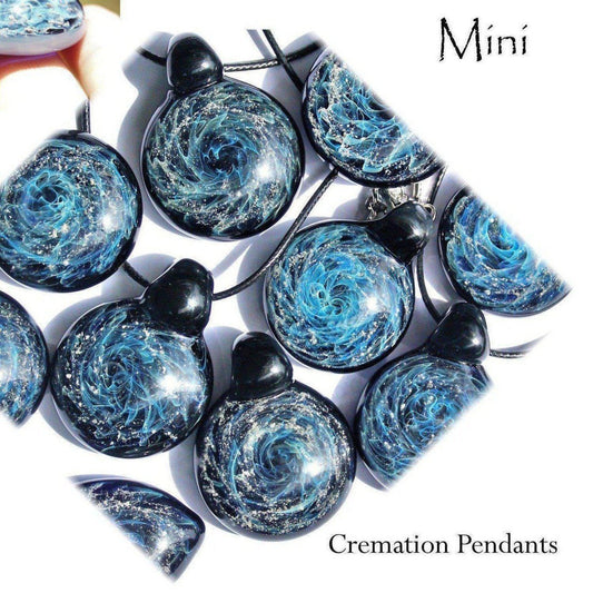 Galaxy Mini Glass Cremation Pendant featuring swirling blue and silver galaxy design, handmade with ashes for memorial jewelry keepsake.