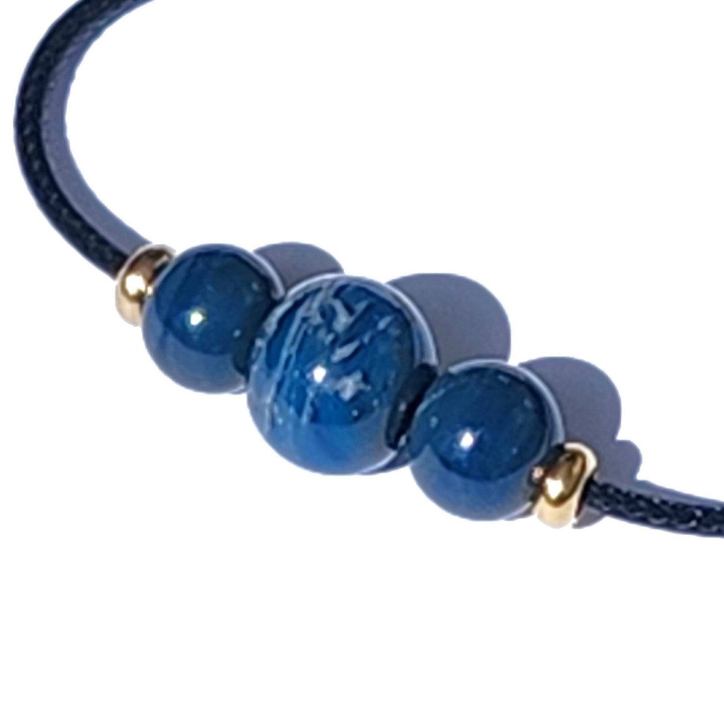 Blue Forever Close Ashes Necklace with ash-infused center bead and gold accents. Cremation jewelry on black cord for remembrance.