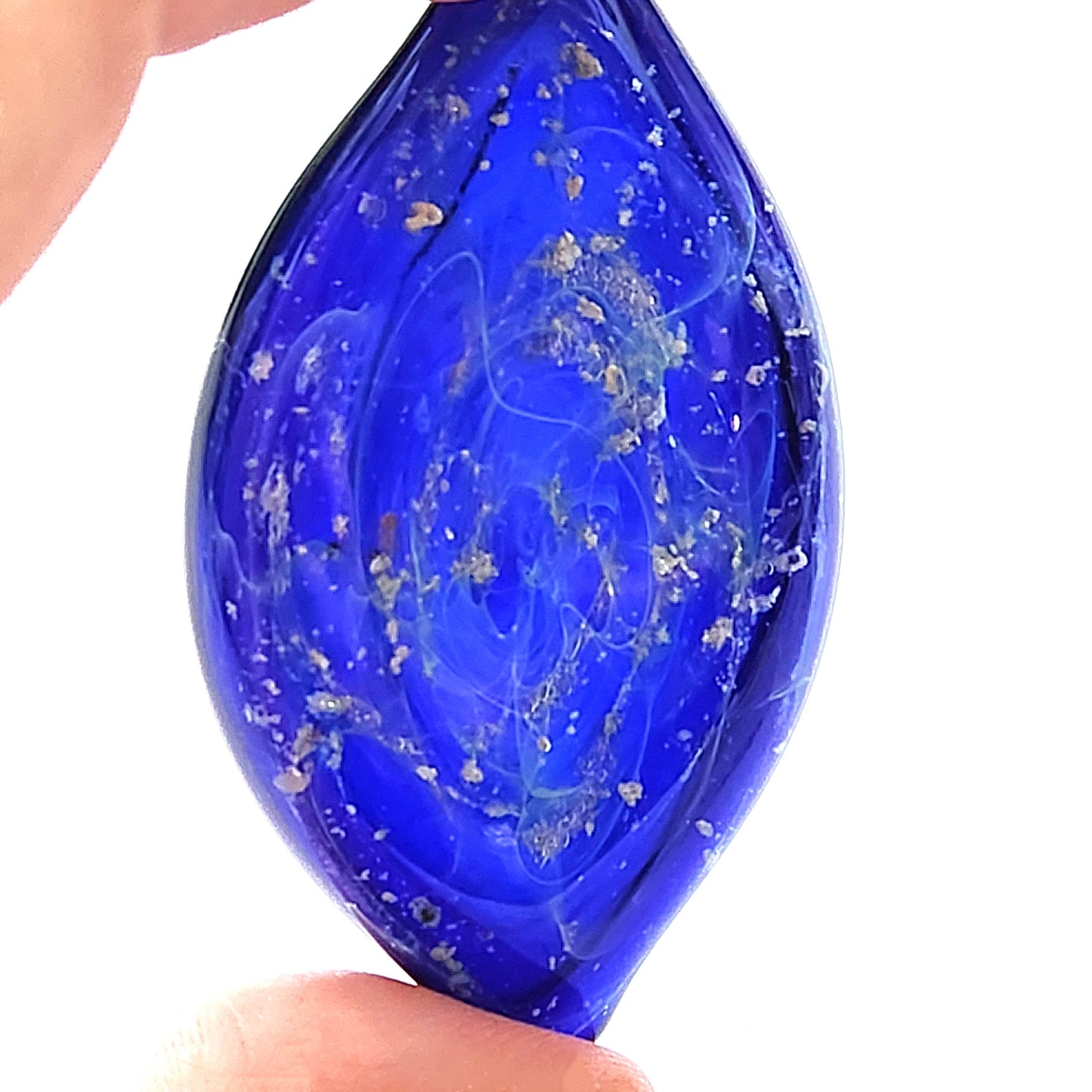 Galaxy Cremation Touchstone in deep blue glass with ashes swirled in a galaxy design. A unique memorial glass keepsake for honoring loved ones.