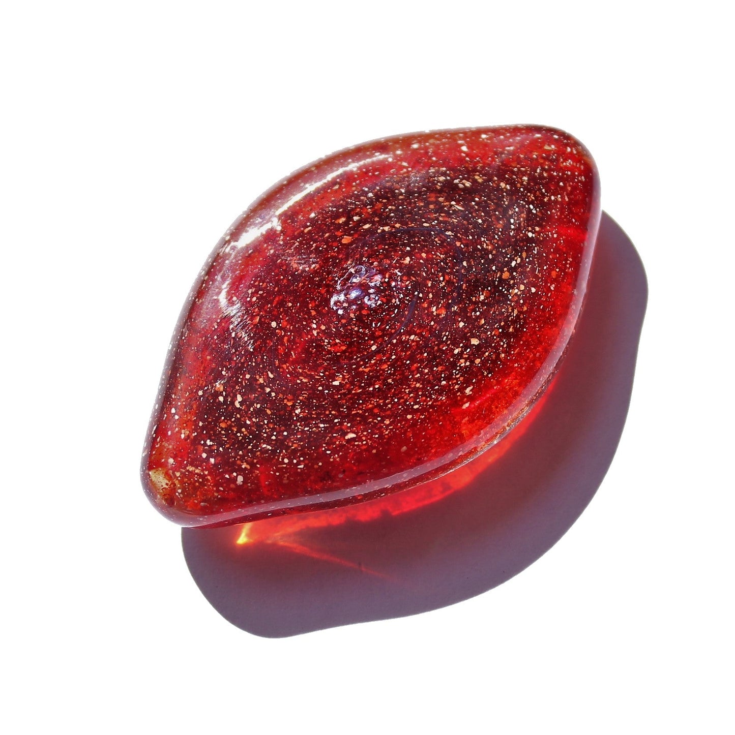 Galaxy Cremation Touchstone in shimmering red with infused ashes, a handmade memorial glass keepsake for remembrance and display.