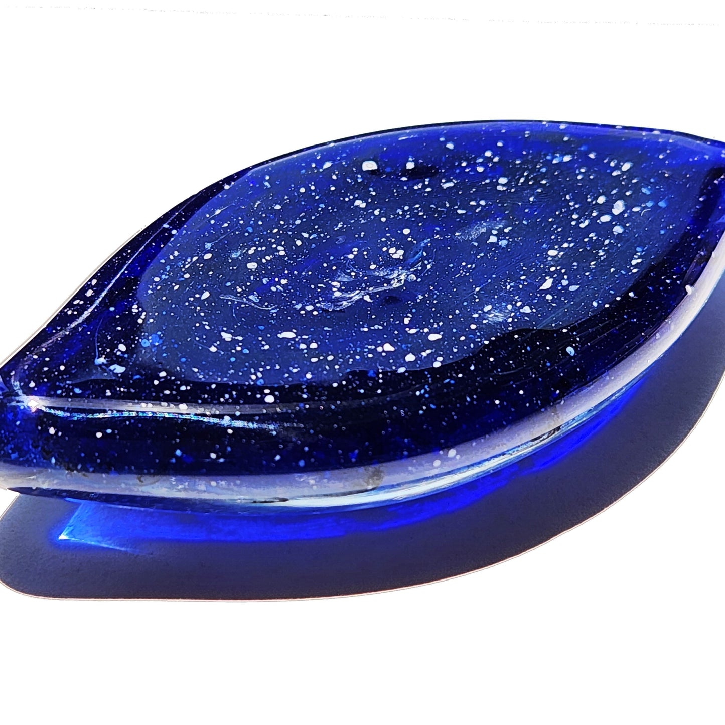 Galaxy Cremation Touchstone | Memorial Glass Keepsake with Ashes in deep blue with white speckles, shaped like a leaf for display or carrying.