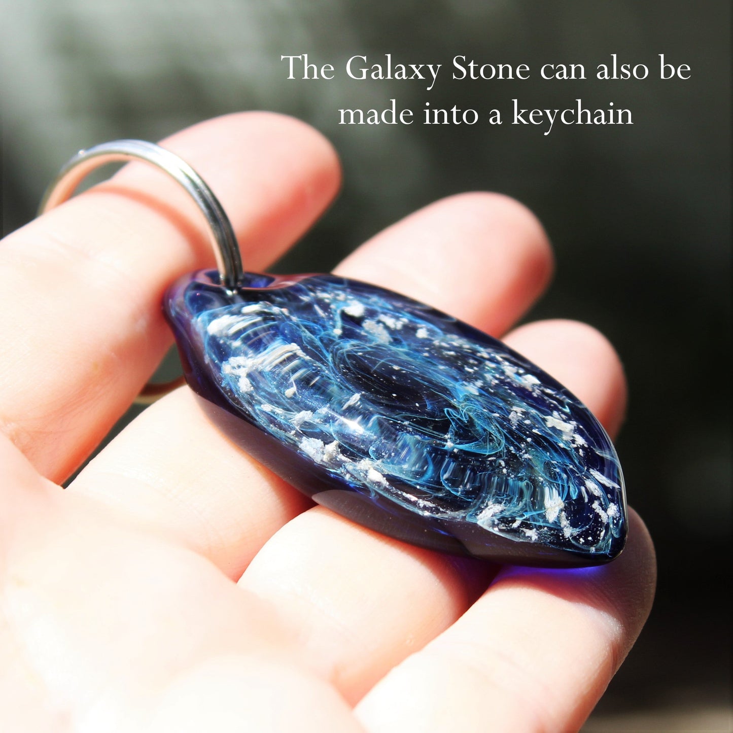Galaxy Cremation Touchstone keychain with ashes in swirling blue, purple, and turquoise glass. A unique memorial keepsake for remembrance ceremonies.
