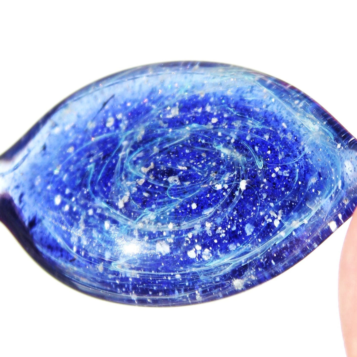 Galaxy Cremation Touchstone memorial glass keepsake with ashes in swirling blue, purple, and turquoise tones. Durable and waterproof for display or carrying.