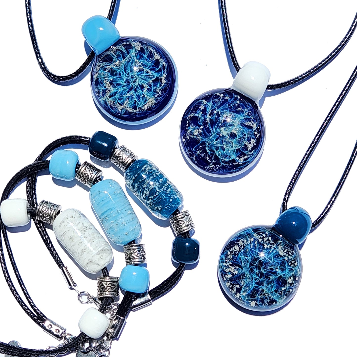 Cremation jewelry set featuring handmade glass urn pendants and memorial bracelets in blue tones. Ideal for ashes keepsakes for pets or loved ones.