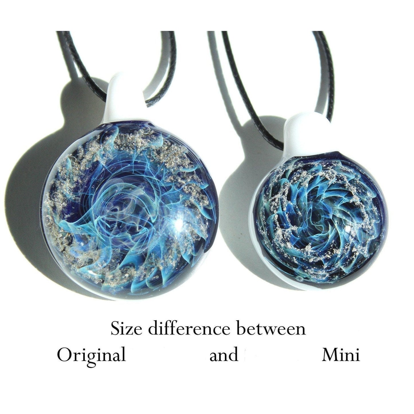Galaxy Cremation Pendant – Handmade Ashes Memorial Necklace shown in original and mini sizes with swirling blue, silver, and ash design in glass.
