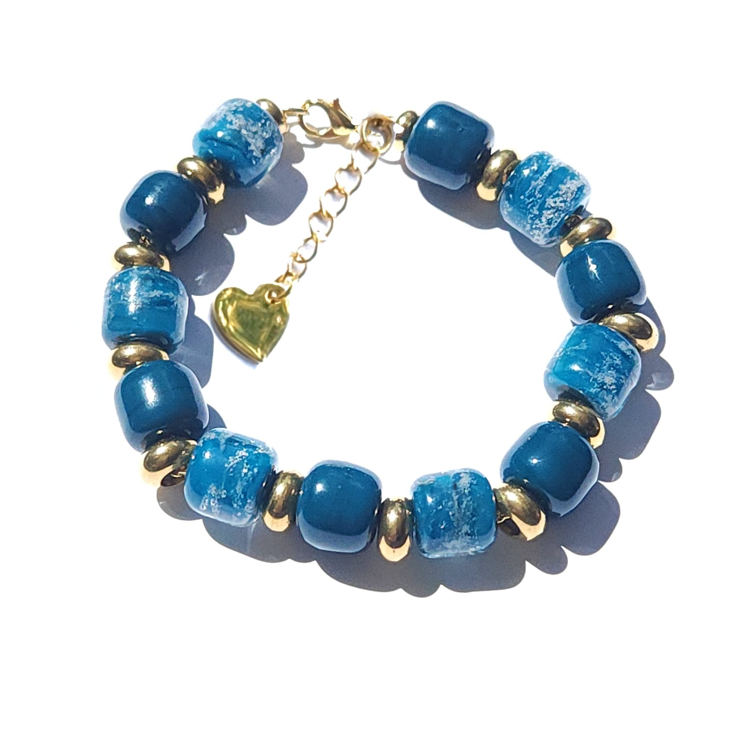 Ocean Blue Memorial Bracelet featuring ash-infused glass cremation beads and gold-tone spacers. Handmade tribute jewelry for memorial ceremonies.