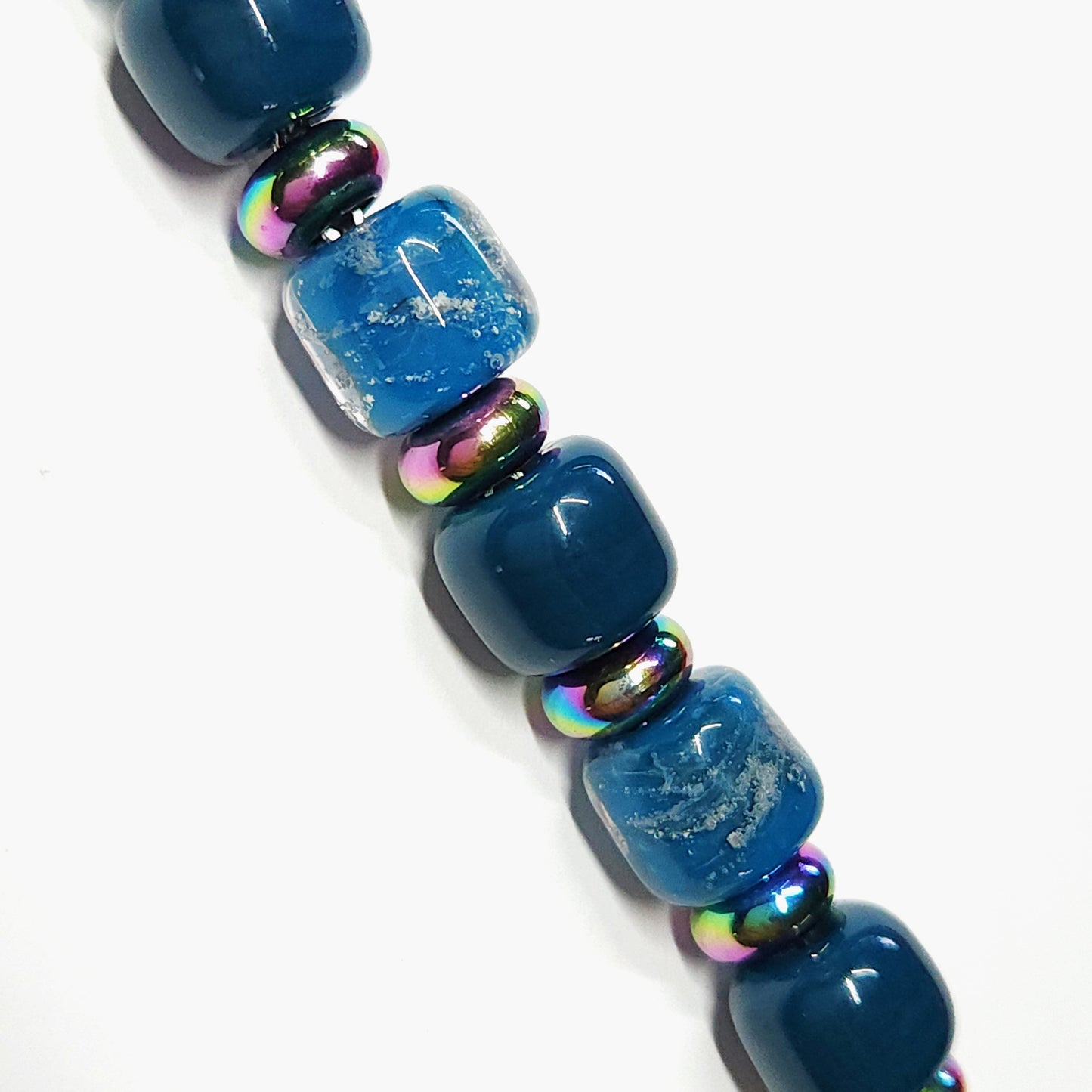 Ocean Blue Memorial Bracelet featuring ash-infused glass cremation beads with iridescent steel spacers. Handmade tribute jewelry for remembrance.