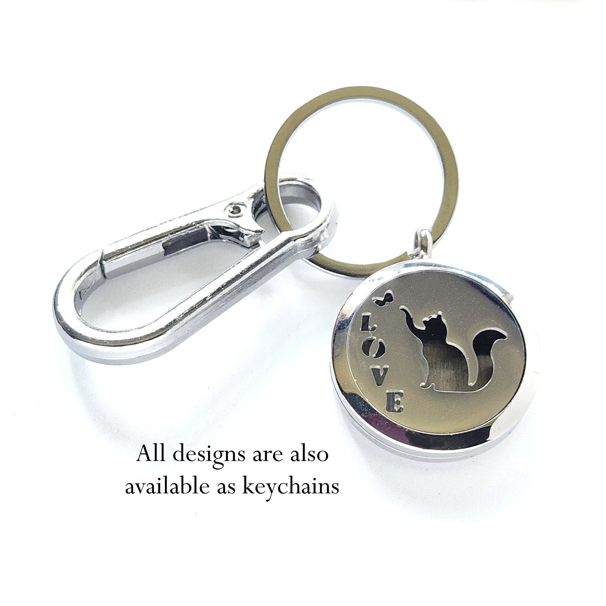 Stainless steel pet memorial cremation pendant with cat silhouette and 'LOVE' text shown as a keychain with clip and ring.