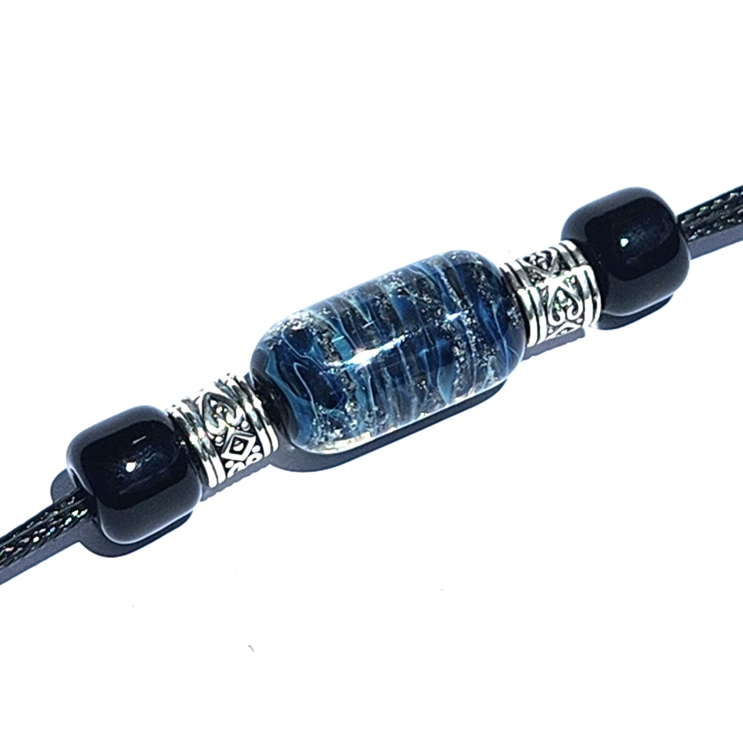 Bracelet with ashes featuring a blue cremation bead, black accents, and silver heart-detailed spacers. Part of the Remember Me Urn Bracelet collection.