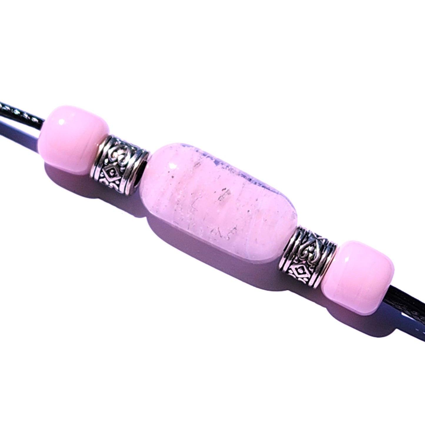 Pink Remember Me cremation bracelet with ashes, featuring handmade glass cremation beads and ornate silver spacers on a black cord. Memorial jewelry for daily wear.