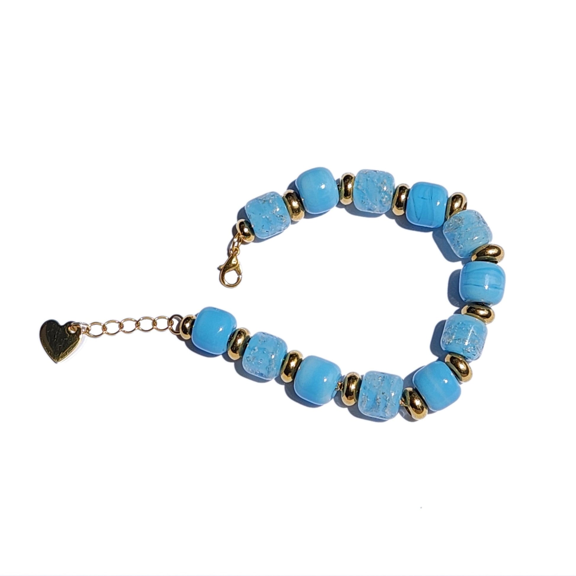 Angled view of Sky Blue Cremation Bracelet with gold heart charm and ash-infused beads, designed for memorial ceremonies.