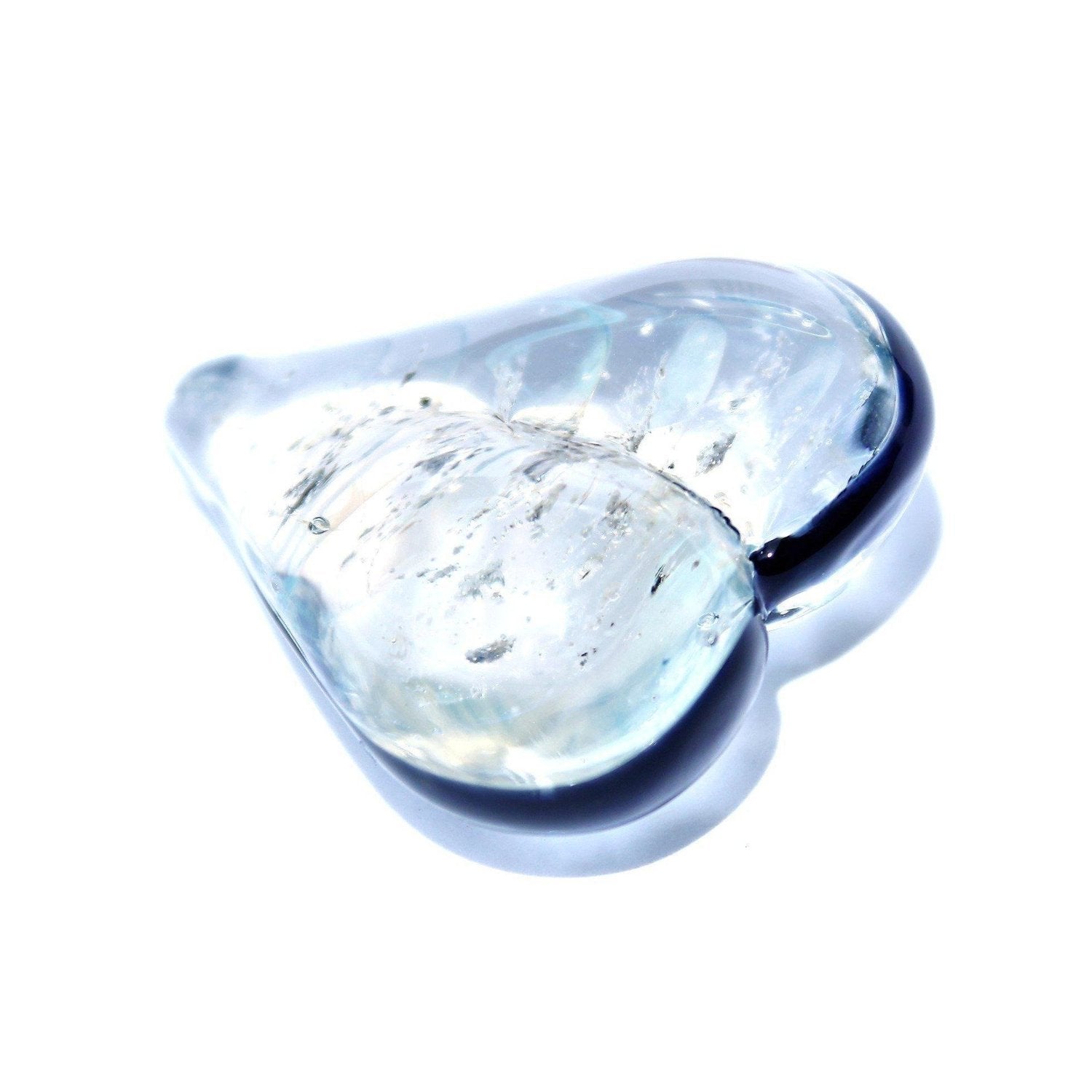 Heart-shaped cremation touchstone with ashes in clear glass and black edge, a memorial keepsake for loved ones or pets.